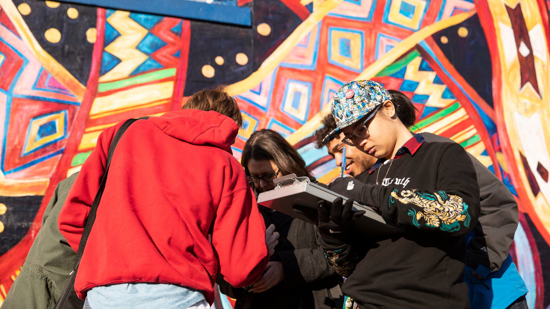 students work with professors to research and digitally map murals in the Midway neighborhood of St. Paul