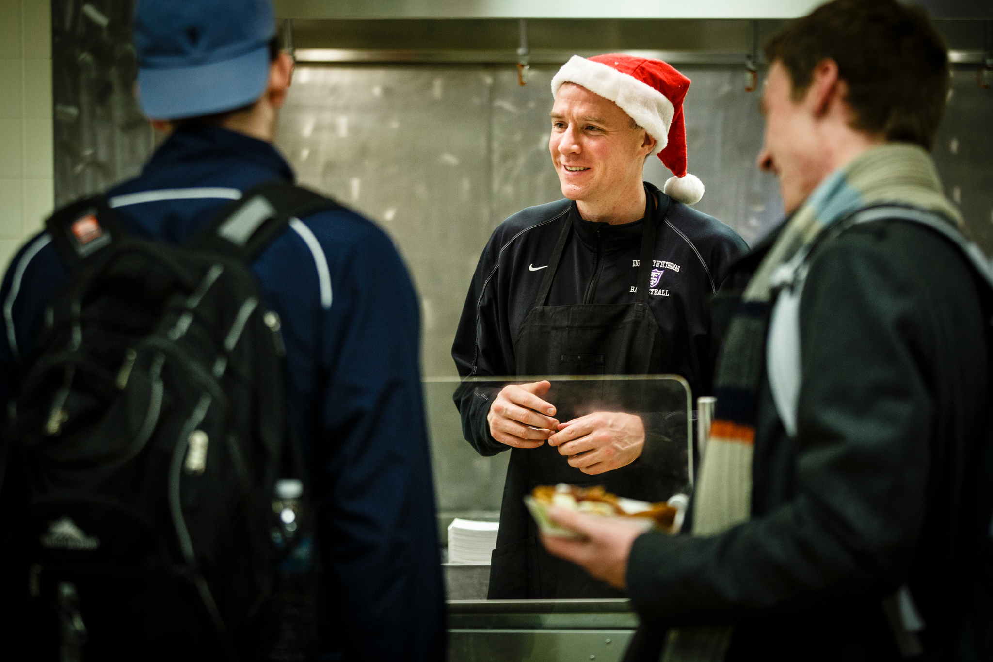 Coach John Tauer serves in T's during a past holiday season