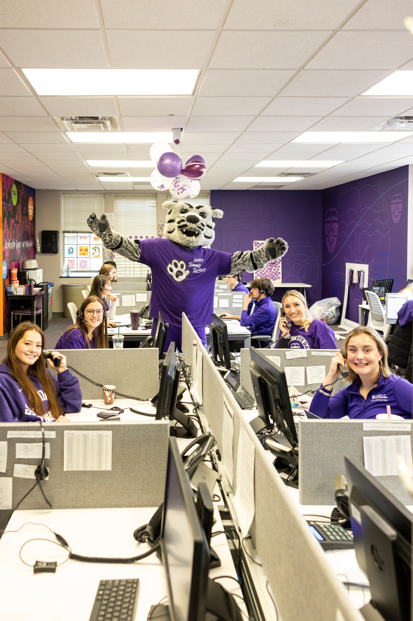 Tommie in the engagement center surrounded by students making calls for Tommie Give Day
