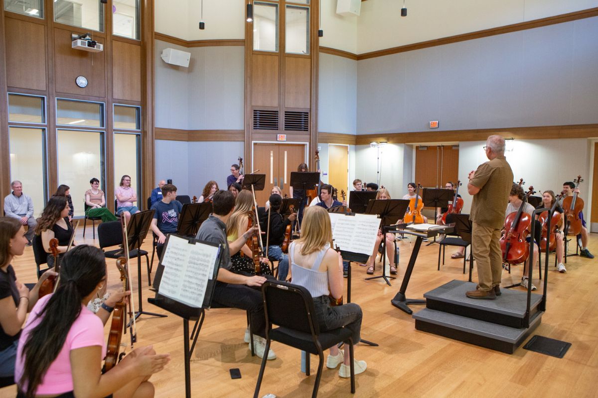 Students during an orchestra rehearsal in the Sarah Rose Hall in the Schoenecker Center