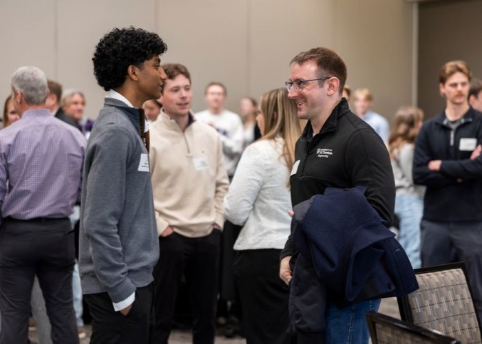 Student and Tommie alum connect during Tommies Together event in Woulfe Alumni Hall