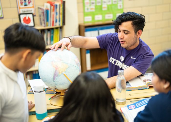 St. Thomas student interacts with children in a classroom