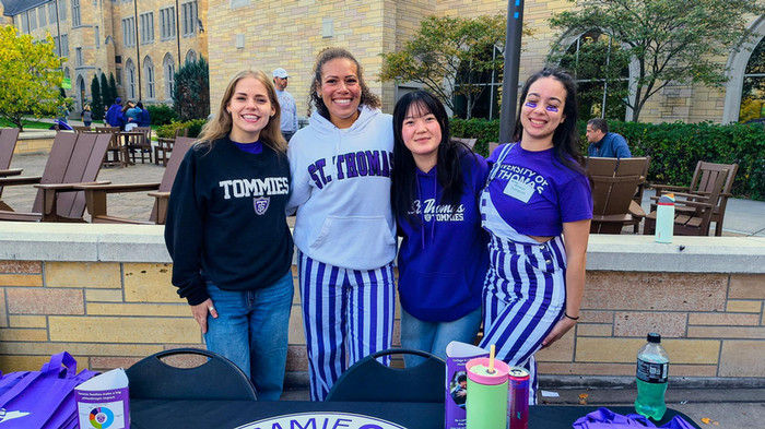 Four Engagement Center students on the quad enjoying Homecoming