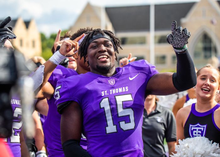 St. Thomas football player celebrates after a win