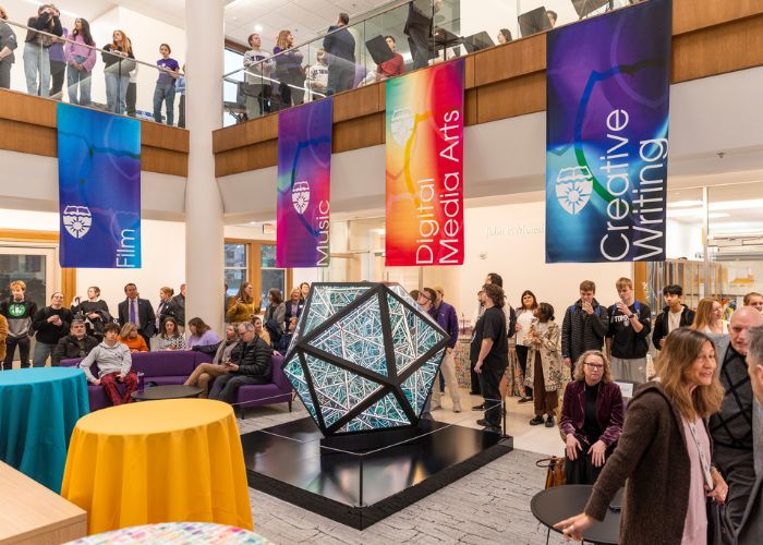 Schoenecker Center main atrium is decorated with colored banners as students, staff and faculty gather for a celebration of the arts.