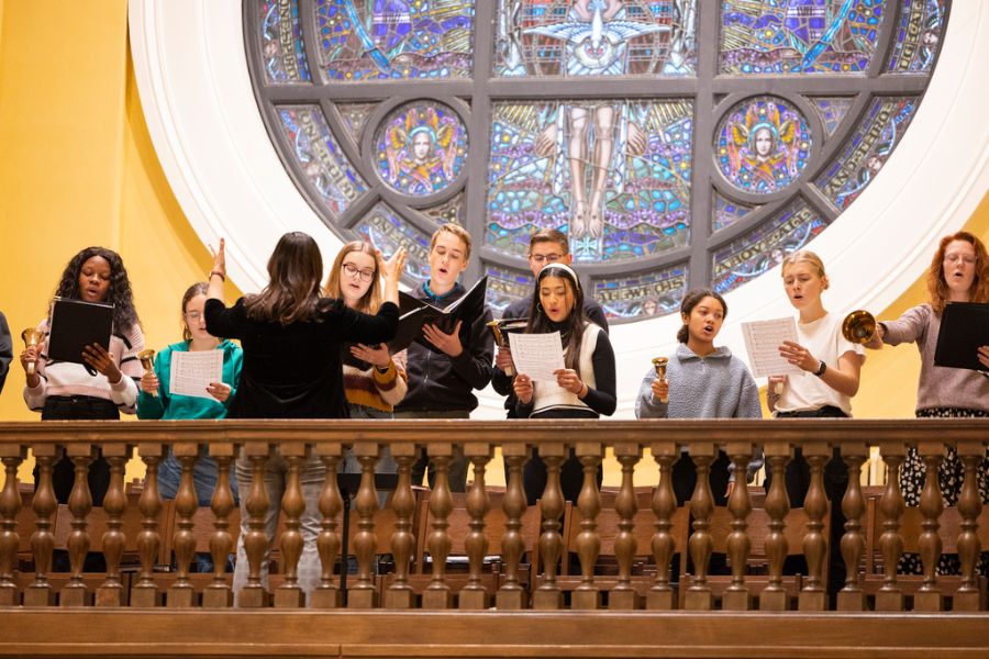 Choir students performing in the Aquinas Chapel during the Claritas Event, “Sites that Inspire” on December 6, 2023 in St. Paul.