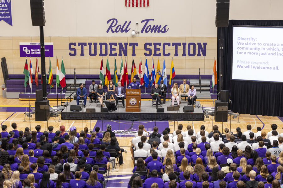 Students gather for convocation in a large gymnasium