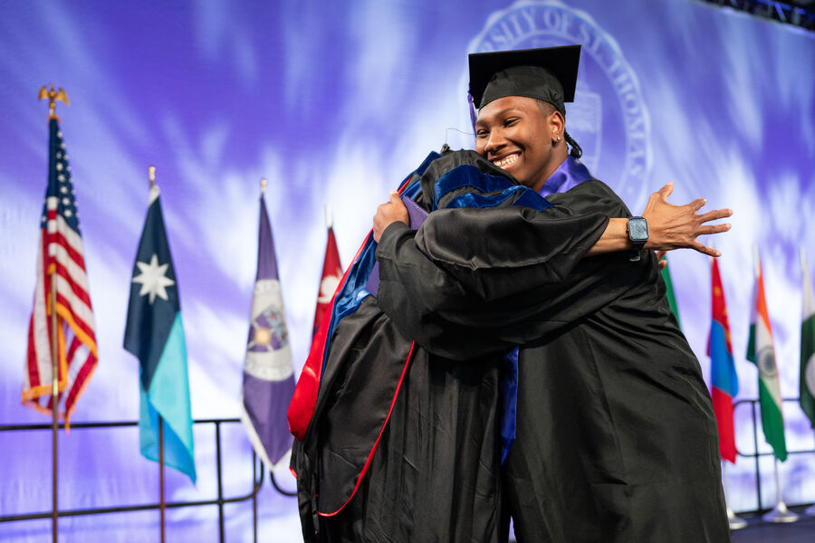 Dean Buffy Smith hugs a student at the Undergraduate Ceremony for Dougherty Family College