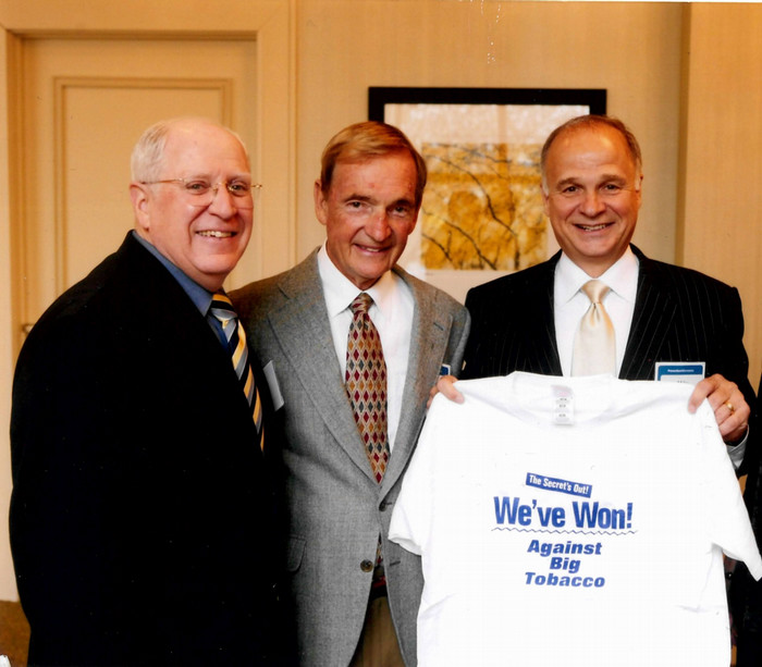 The release of 35 million pages of tobacco industry documents would have thwarted if not for the support of Minnesota Attorney General Skip Humphrey, left, and Blue Cross and Blue Shield of Minnesota CEO Andy Czajkowski, middle. Mike Ciresi ’68 holds the shirt celebrating the win his legal team secured for Minnesota and Blue Cross.