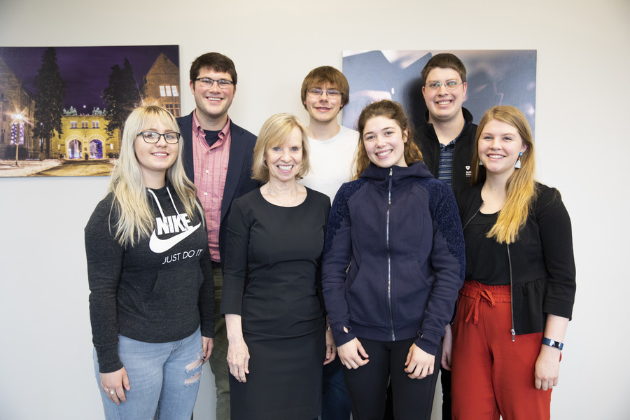 In this file photo, Ann Winblad ’75 meets a few of the recipients of the scholarship named in honor of her parents.