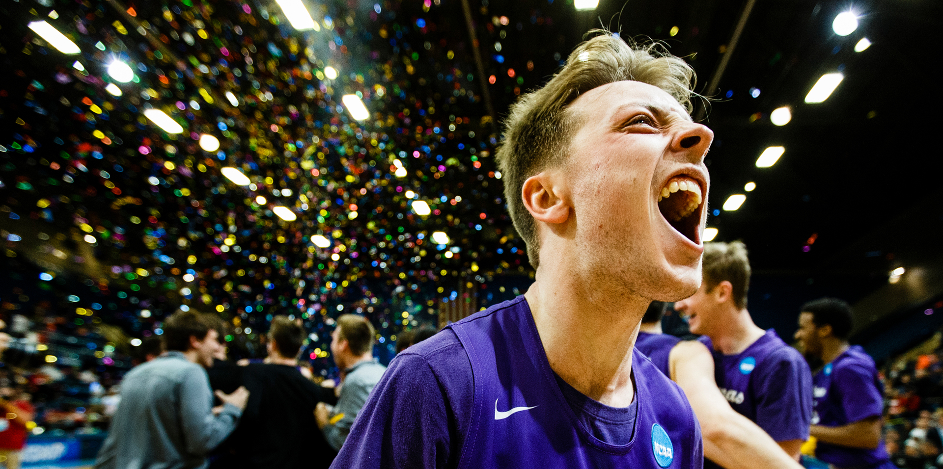 a men's basketball players celebrates after winning the division three national championship