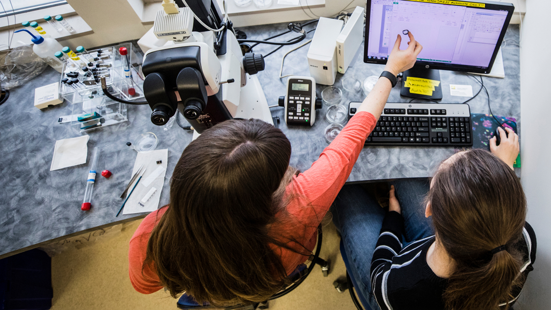   Geology student Sarah Howe, right, and Geology Professor Jeni McDermott, left, work together at a computer in a Geology Lab room in Owens Science Hall on December 11, 2017 in St. Paul. 