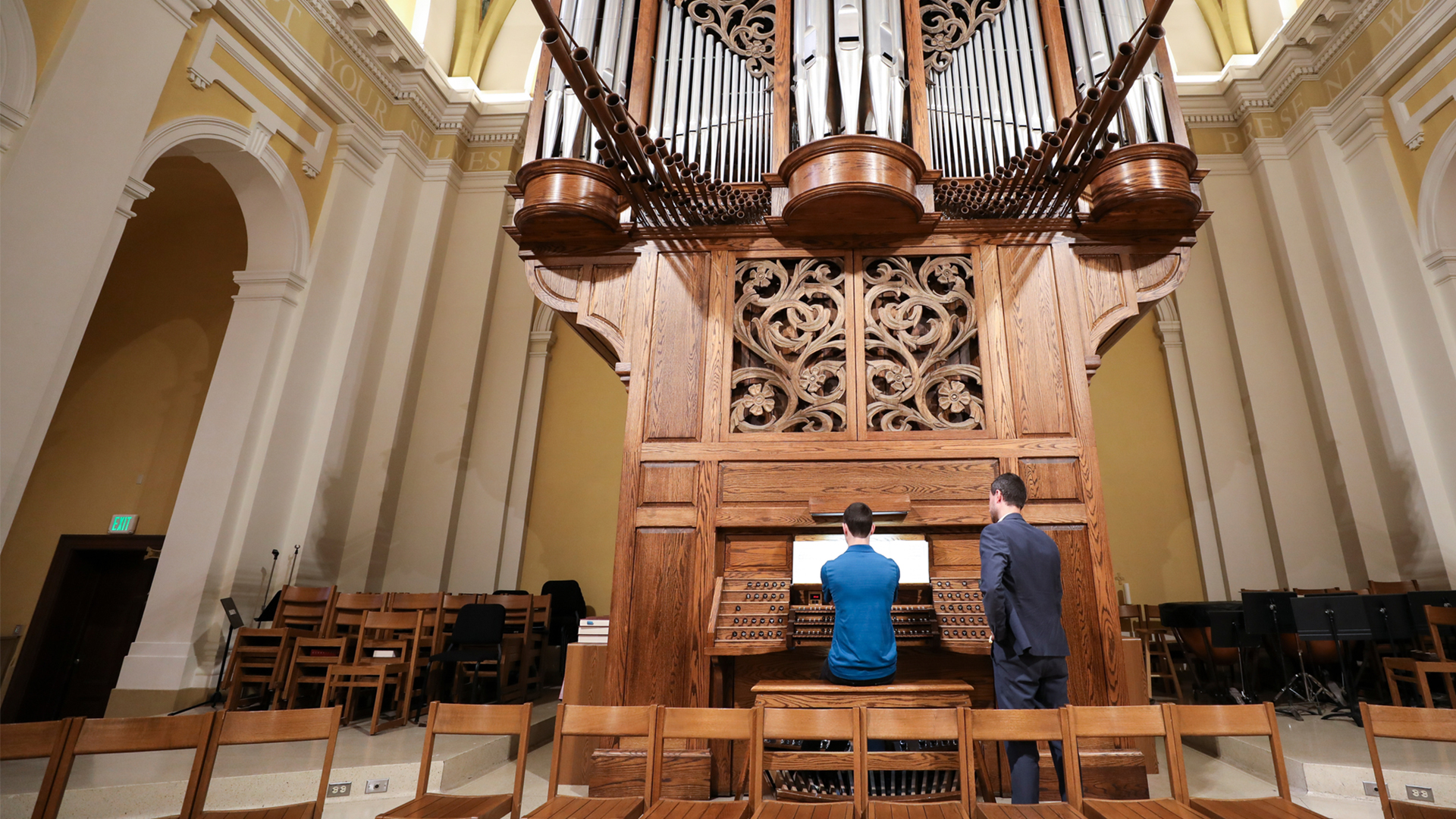 A student is instructed at the organ during a lesson in the Chapel of St. Thomas Aquinas