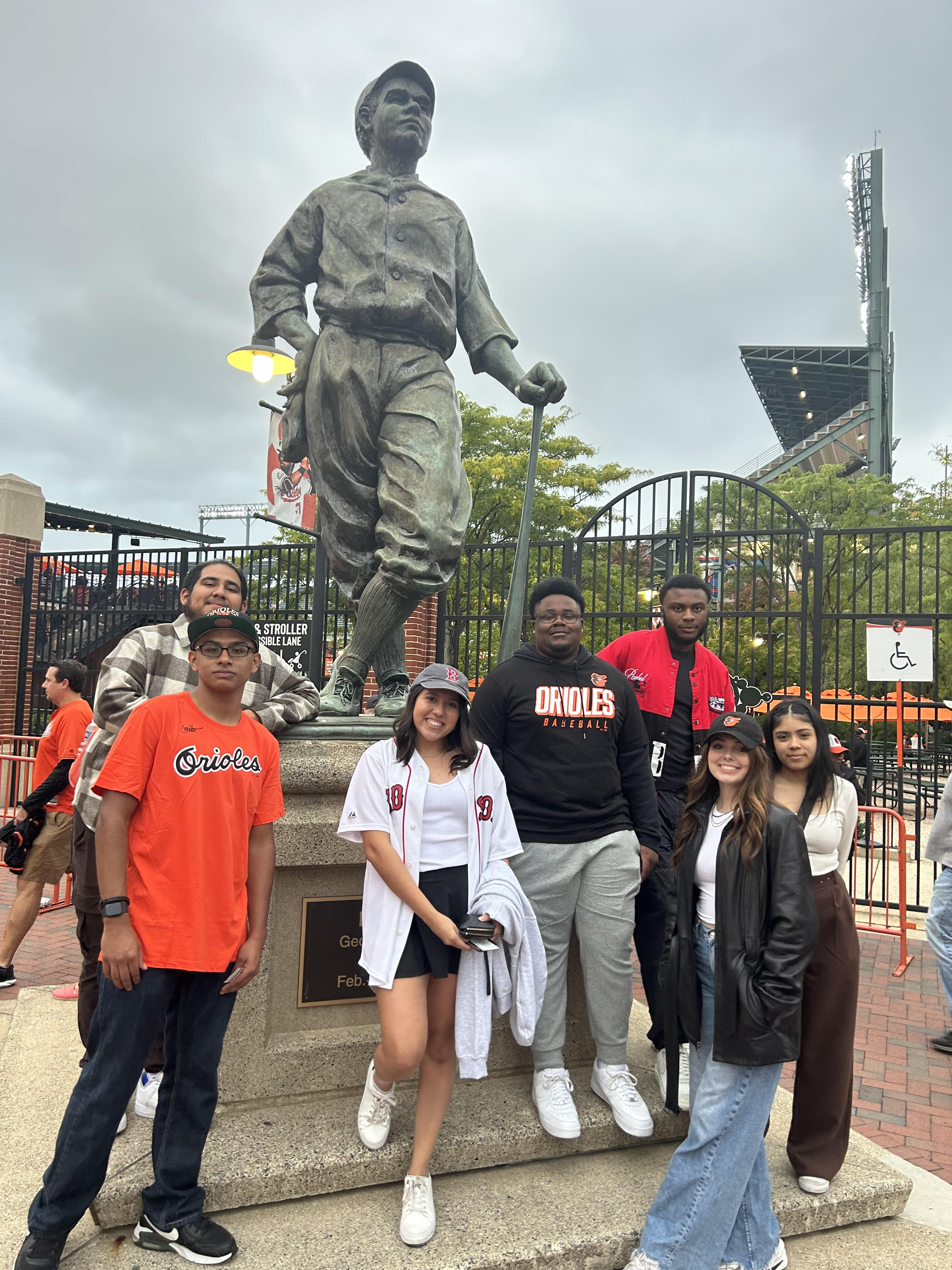 Students dressed up in Orioles clothing for a baseball game