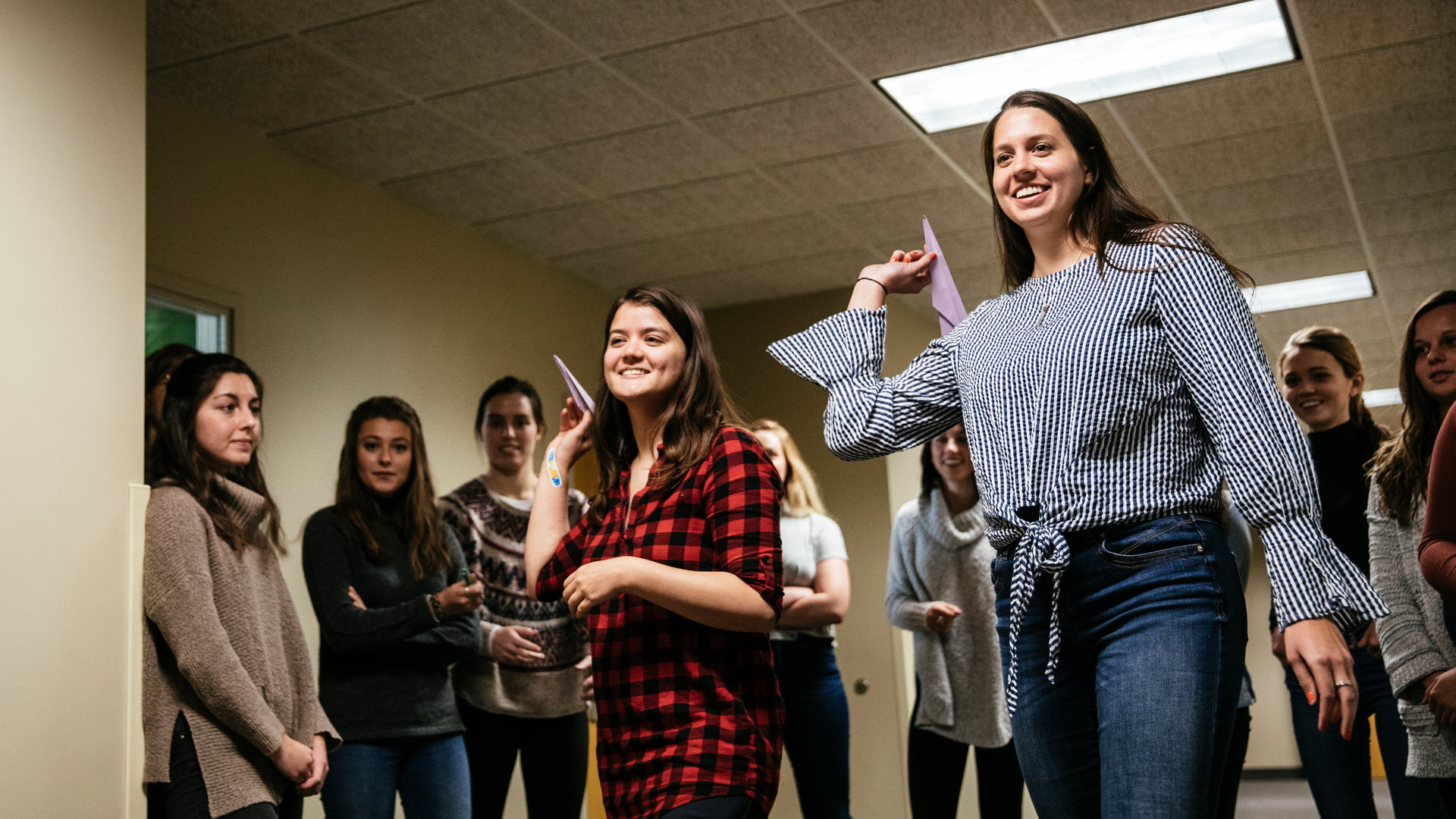 students throw paper airplanes during an education class dedicated to engineering