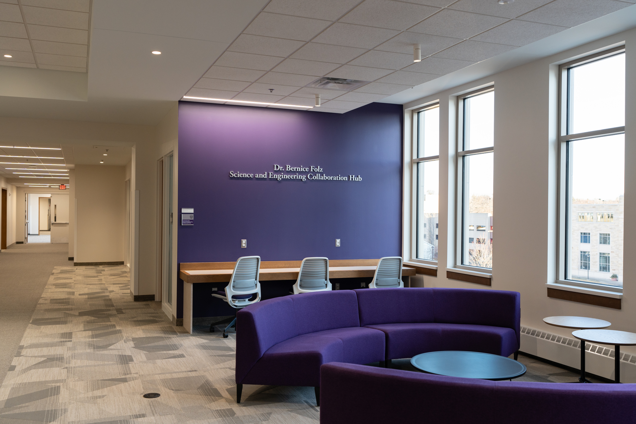 A collaboration area with purple couches and study area