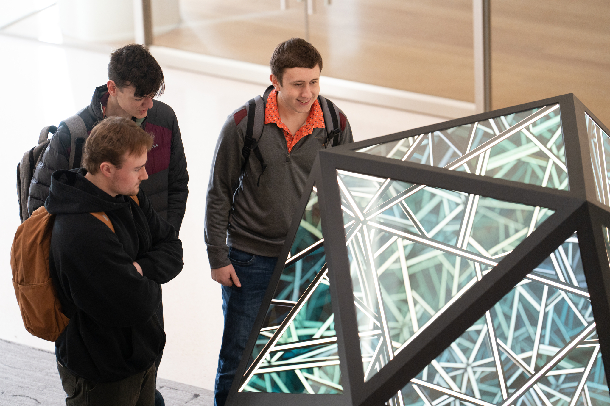 Students looking at the beautiful shape sculpture in the atrium