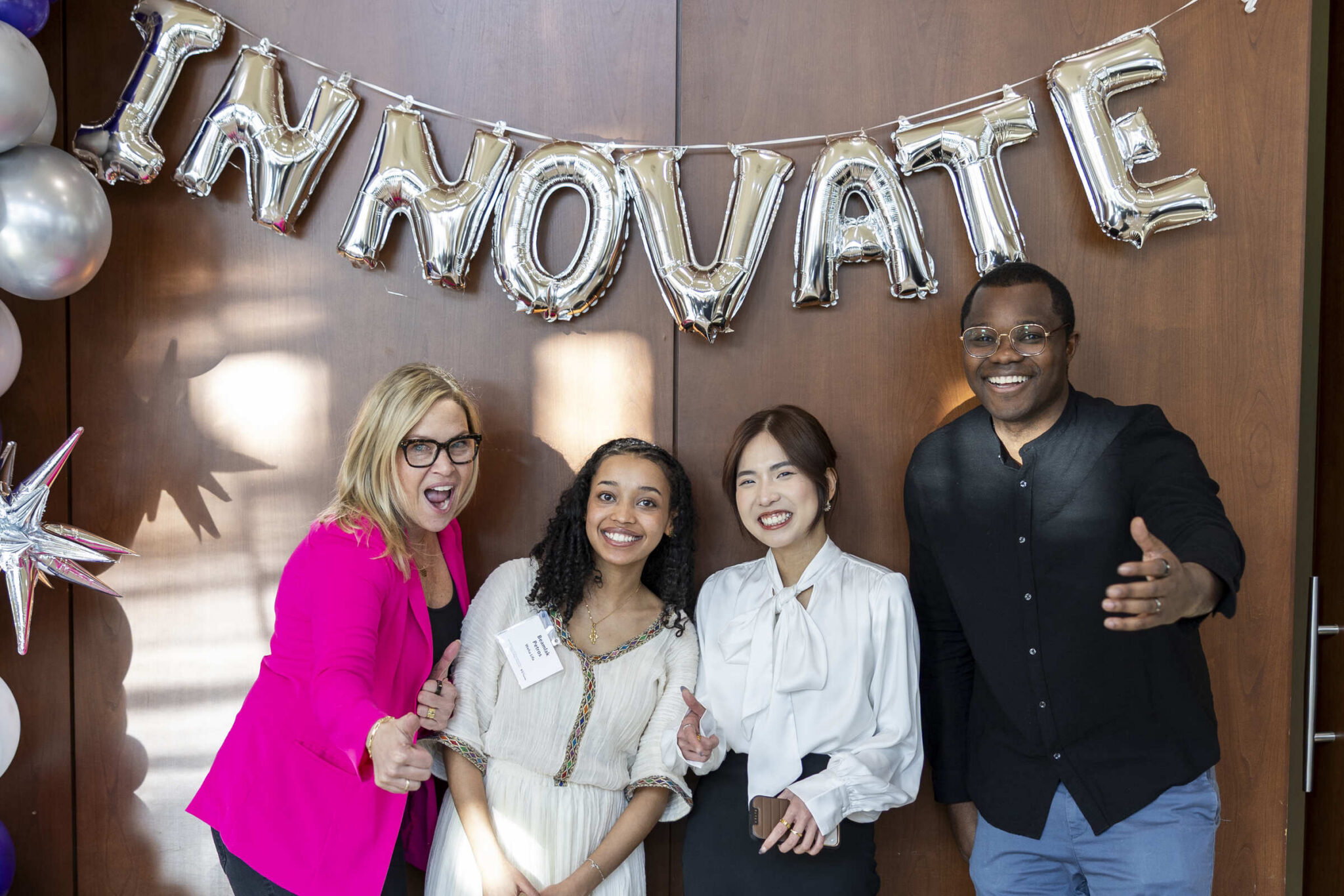 four people celebrating in a posed photo
