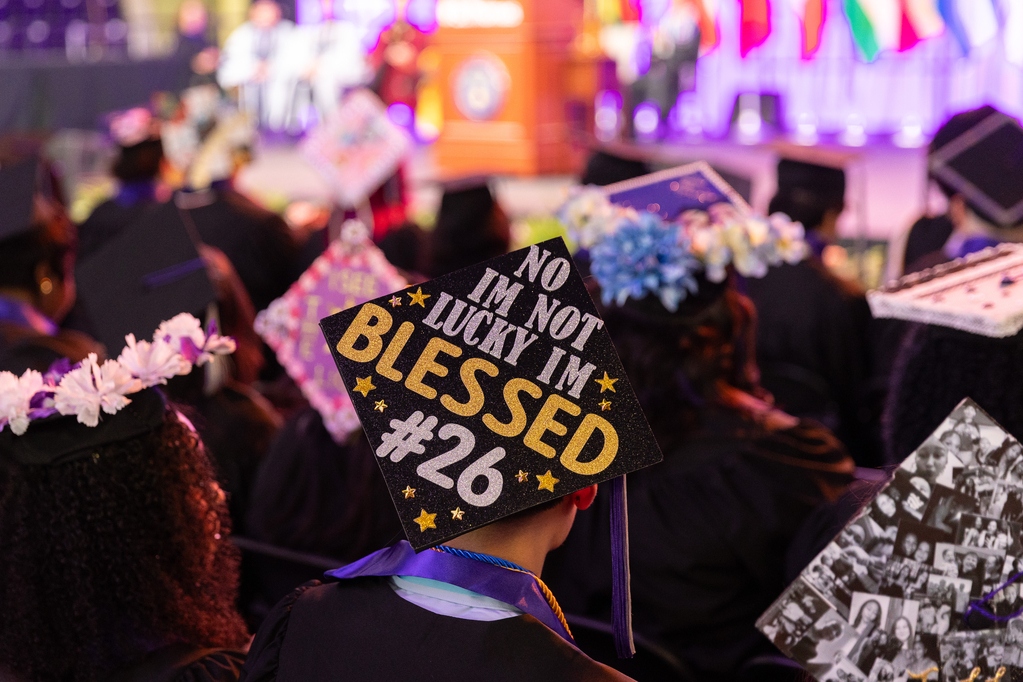 Photo looking down on a graduate's mortar board which reads I'm not lucky I'm blessed.